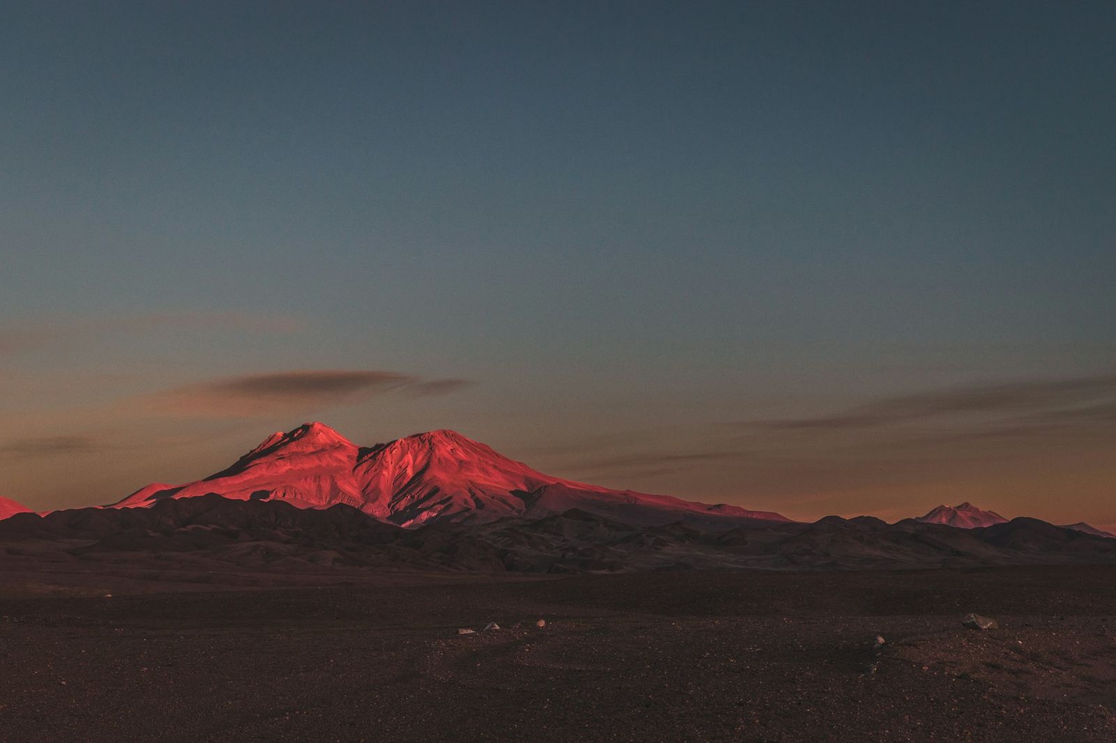 First light turning an Andean peak red at dawn