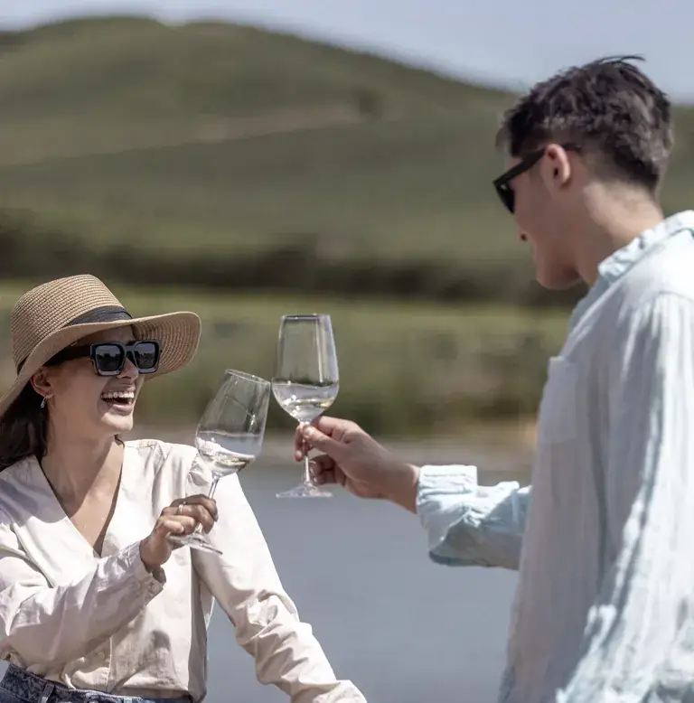 Two visitors toasting with white wine at Casas del Bosque