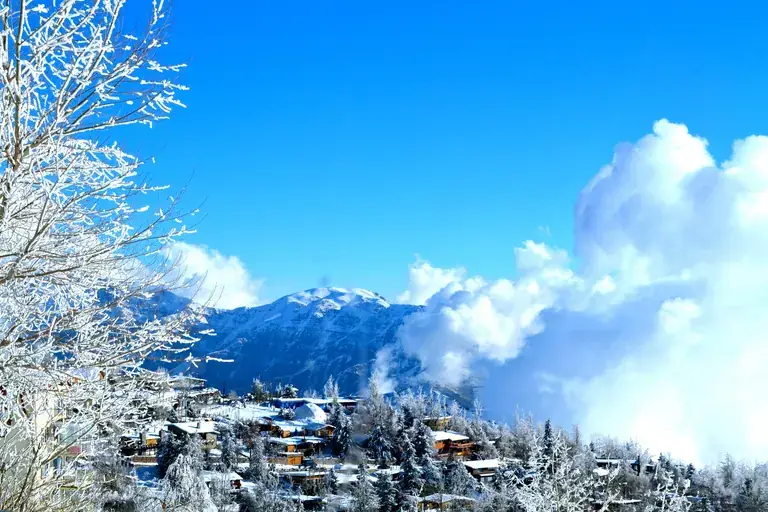 The village of Farellones covered in snow, with the Andes behind