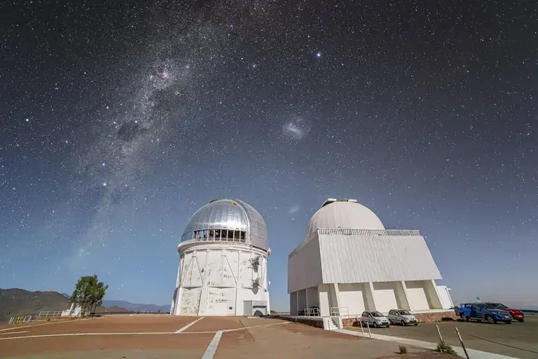 Telescope domes under the Milky Way in the Chilean night sky
