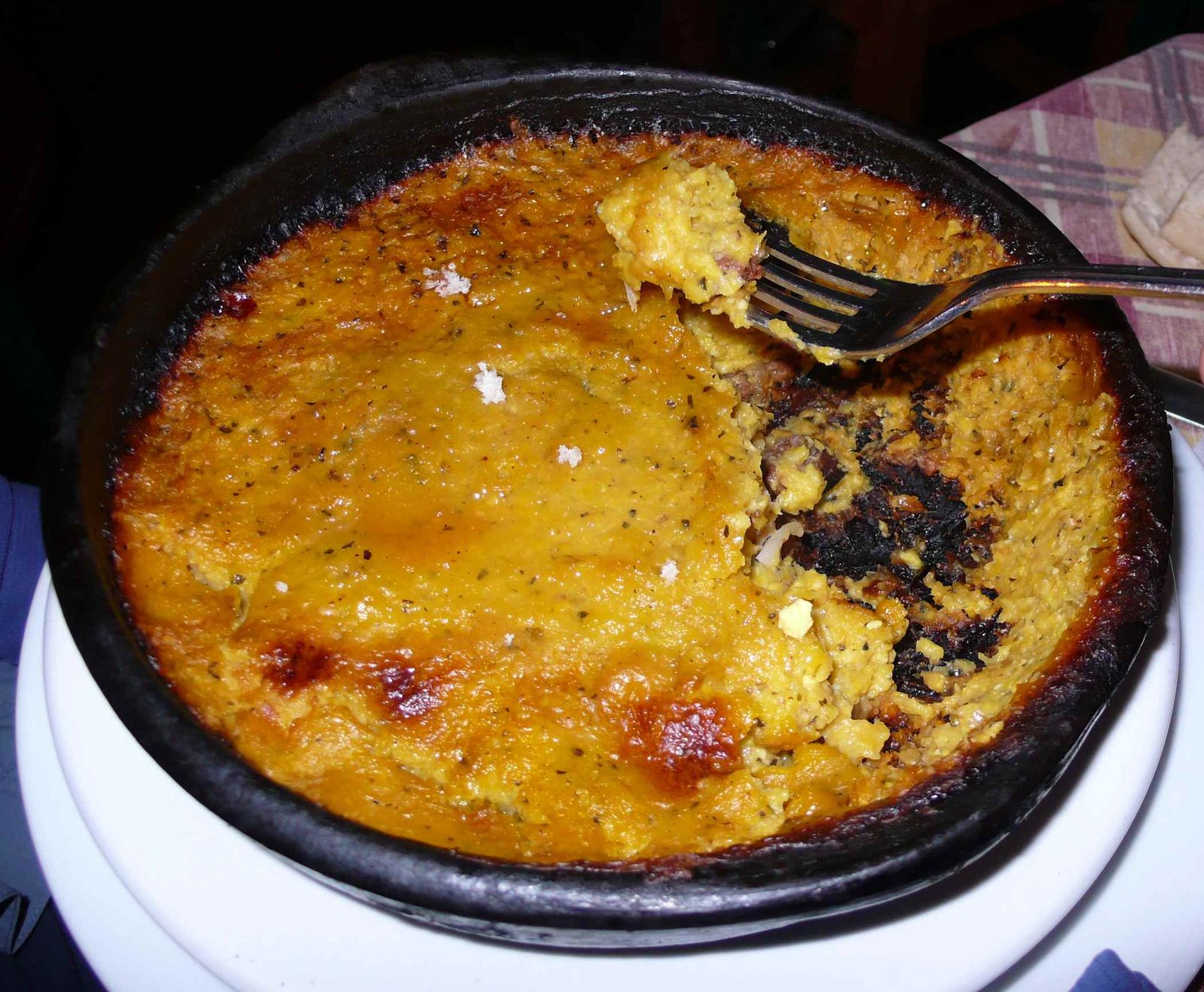 Pastel de choclo baked in a clay dish
